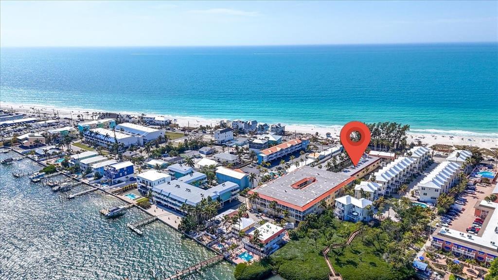 An aerial view shows a coastal resort complex with a red location pin — 1325 GULF DRIVE N UNIT 125, BRADENTON BEACH, FL