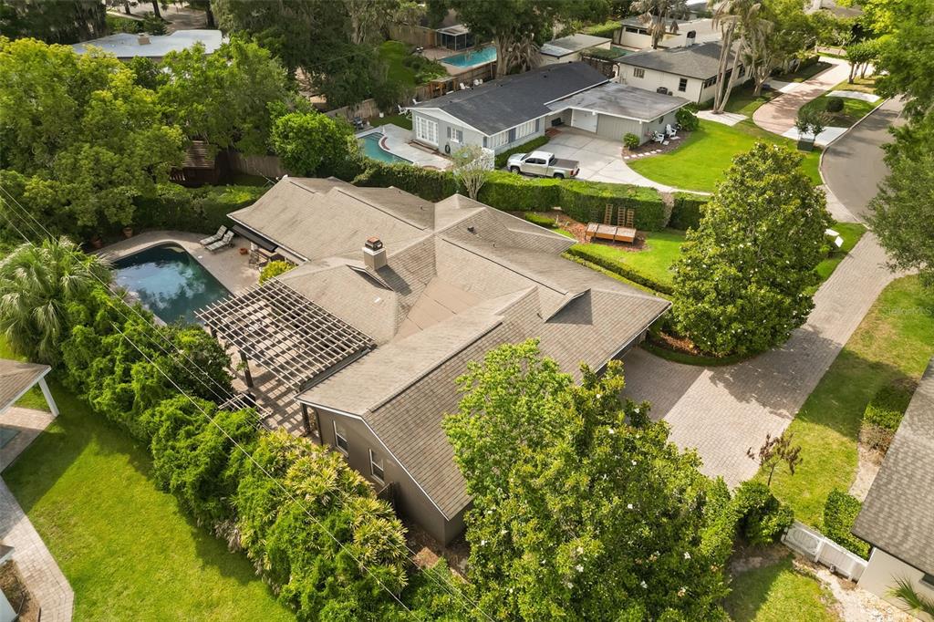An aerial view shows a house with a shingled roof, pool, and pergola — 119 HOLLIE COURT, MAITLAND, FL