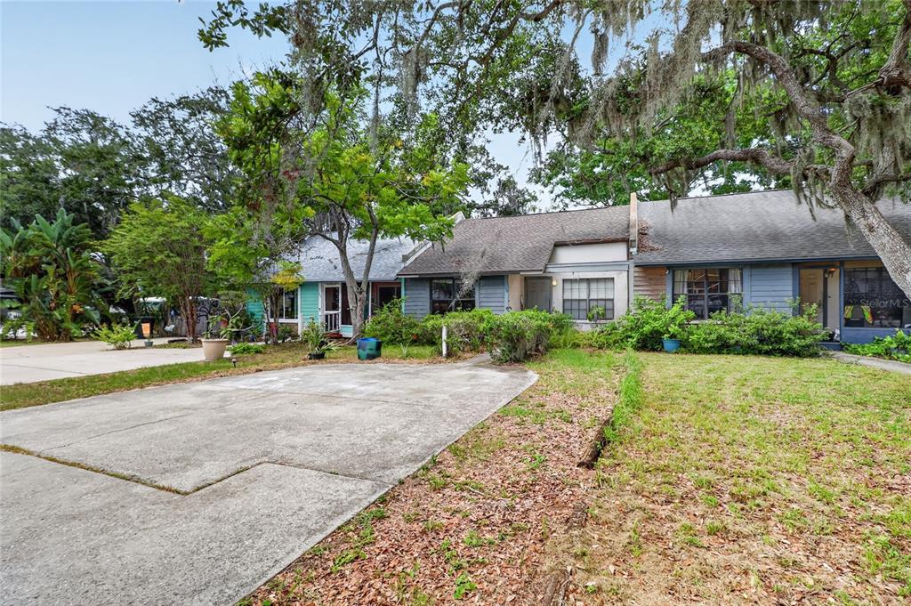 A concrete driveway leads to the front of a single-story multi-unit residential building — 108 12TH AVENUE S, SAFETY HARBOR, FL