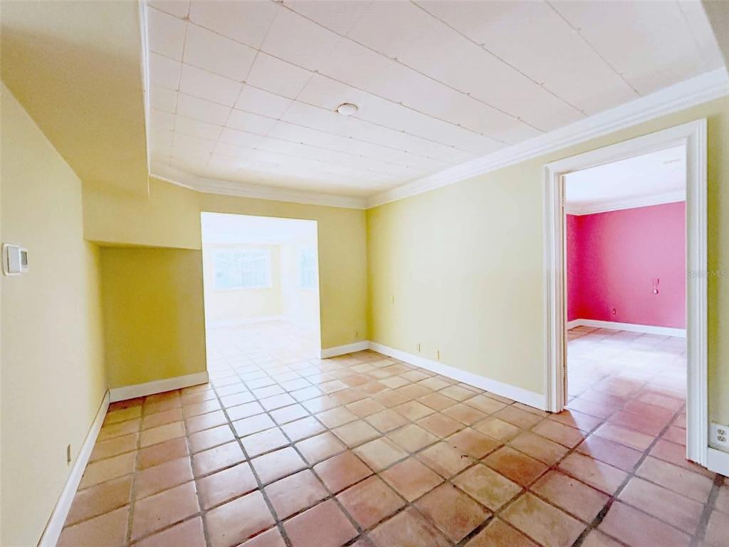 An interior room with light yellow walls, a tiled floor, and a white ceiling — 11050 NW 107TH TERRACE, CHIEFLAND, FL