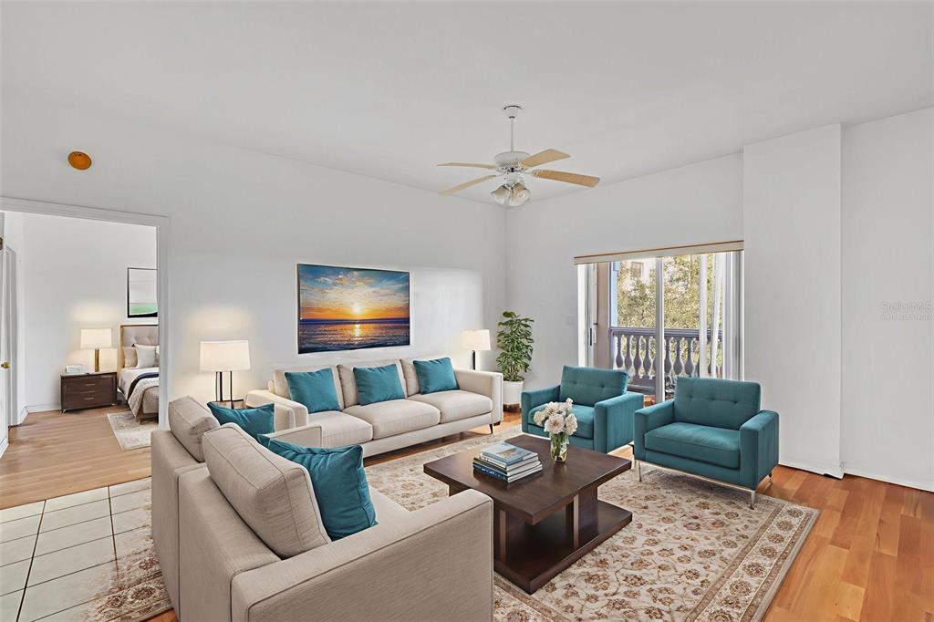 A living room features a beige sofa, two teal armchairs, and a wooden coffee table — 3730 CADBURY CIRCLE UNIT 431, VENICE, FL