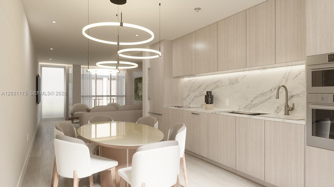 This rendering shows a modern kitchen and dining area with light wood cabinetry and marble — 260 Collins Ave # 302, Miami Beach FL 33139, MIAMI BEACH, FL
