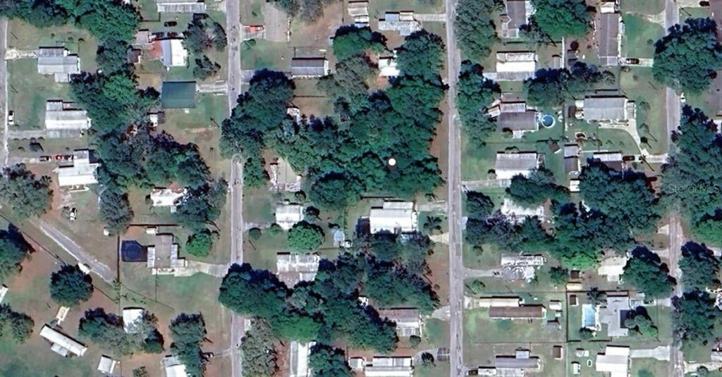 This is an aerial view of a residential neighborhood with houses, trees, and paved streets — SE 173RD COURT, SILVER SPRINGS, FL