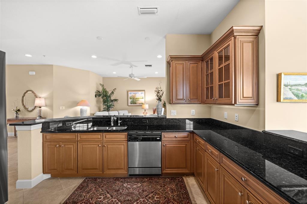 A screened-in patio with tile flooring overlooks a pond and a golf course — 10391 GLASTONBURY CIRCLE UNIT 202, FORT MYERS, FL