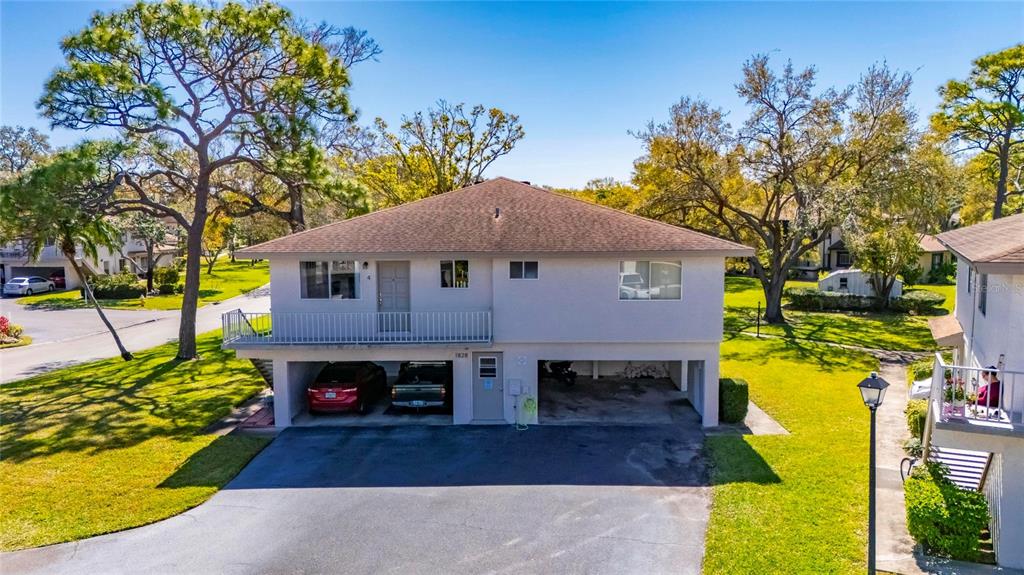 An elevated two-story house with a ground-level carport and a second-story balcony — 1828 BOUGH AVENUE UNIT 3, CLEARWATER, FL