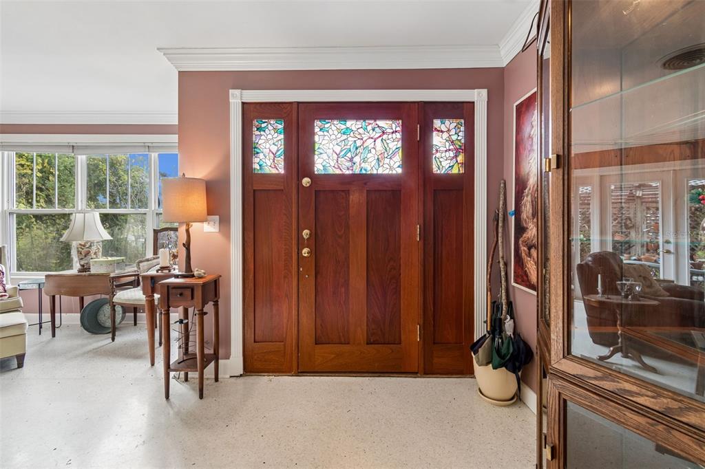 An entryway features a wooden front door with stained glass panels and a side table — 159 BISCAYNE AVENUE, TAMPA, FL