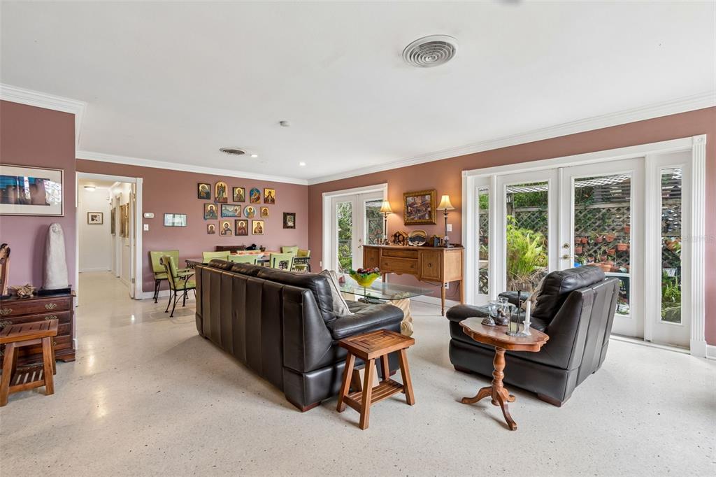 A living room features dark leather furniture, a dining area, and glass doors to a patio — 159 BISCAYNE AVENUE, TAMPA, FL