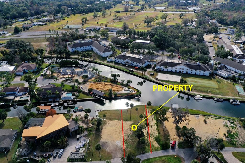 This aerial view shows a vacant waterfront lot marked with red boundary lines — 0 SE 3RD COURT, CRYSTAL RIVER, FL