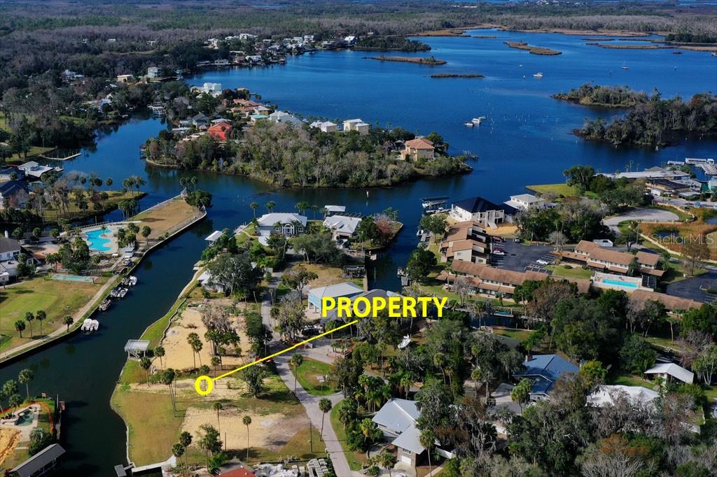 An aerial view shows a vacant waterfront lot situated between two residential canal areas — 0 SE 3RD COURT, CRYSTAL RIVER, FL