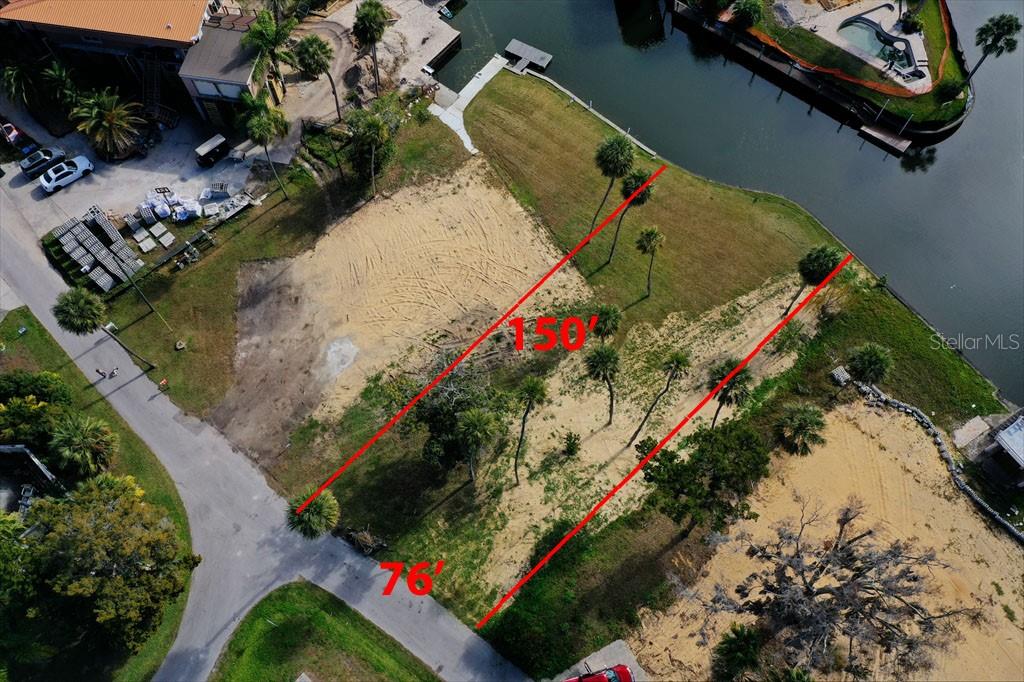 An aerial view shows a vacant waterfront lot with red boundary lines indicating dimensions — 0 SE 3RD COURT, CRYSTAL RIVER, FL