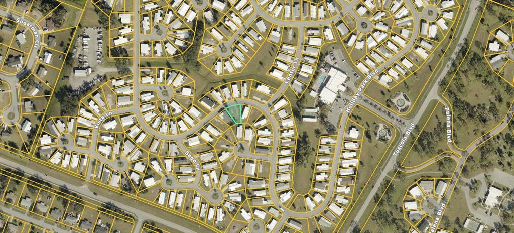 This is an aerial map view of a residential neighborhood with a highlighted vacant lot — 5708 HOLIDAY PARK BLVD, NORTH PORT, FL