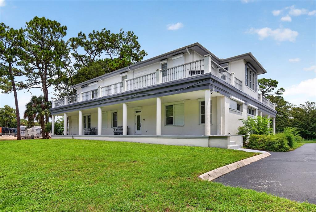 A two-story white house with a wrap-around porch and a second-story balcony — 268 S SUNCOAST BOULEVARD, CRYSTAL RIVER, FL