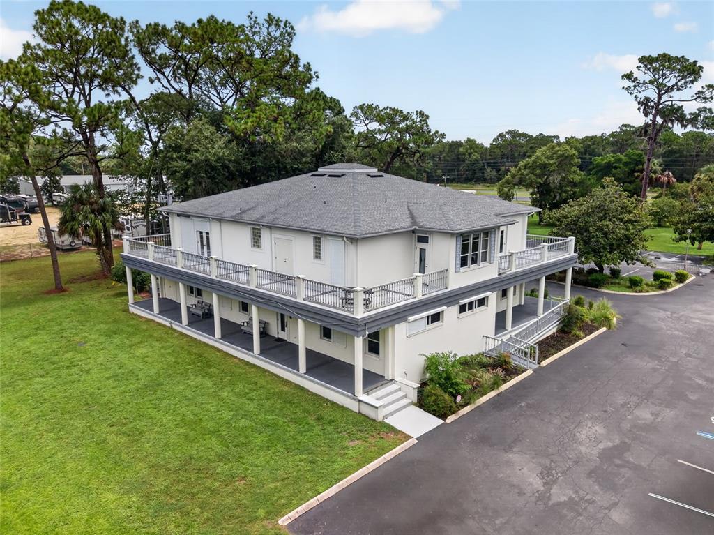 An aerial view of a two-story building with wrap-around porches and a large parking lot — 268 S SUNCOAST BOULEVARD, CRYSTAL RIVER, FL