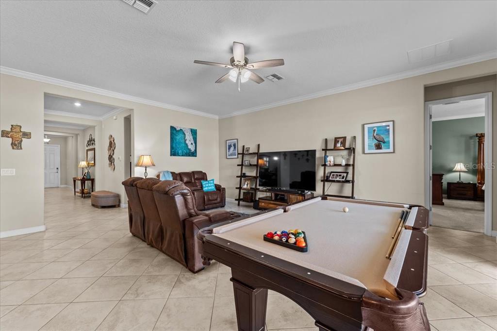 A living room features a pool table, brown leather sofa, and tile flooring — 13443 WHITE SAPPHIRE ROAD, RIVERVIEW, FL