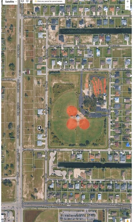 This satellite map shows a residential neighborhood featuring a large park with baseball fields — 1416 SW 7TH COURT, CAPE CORAL, FL