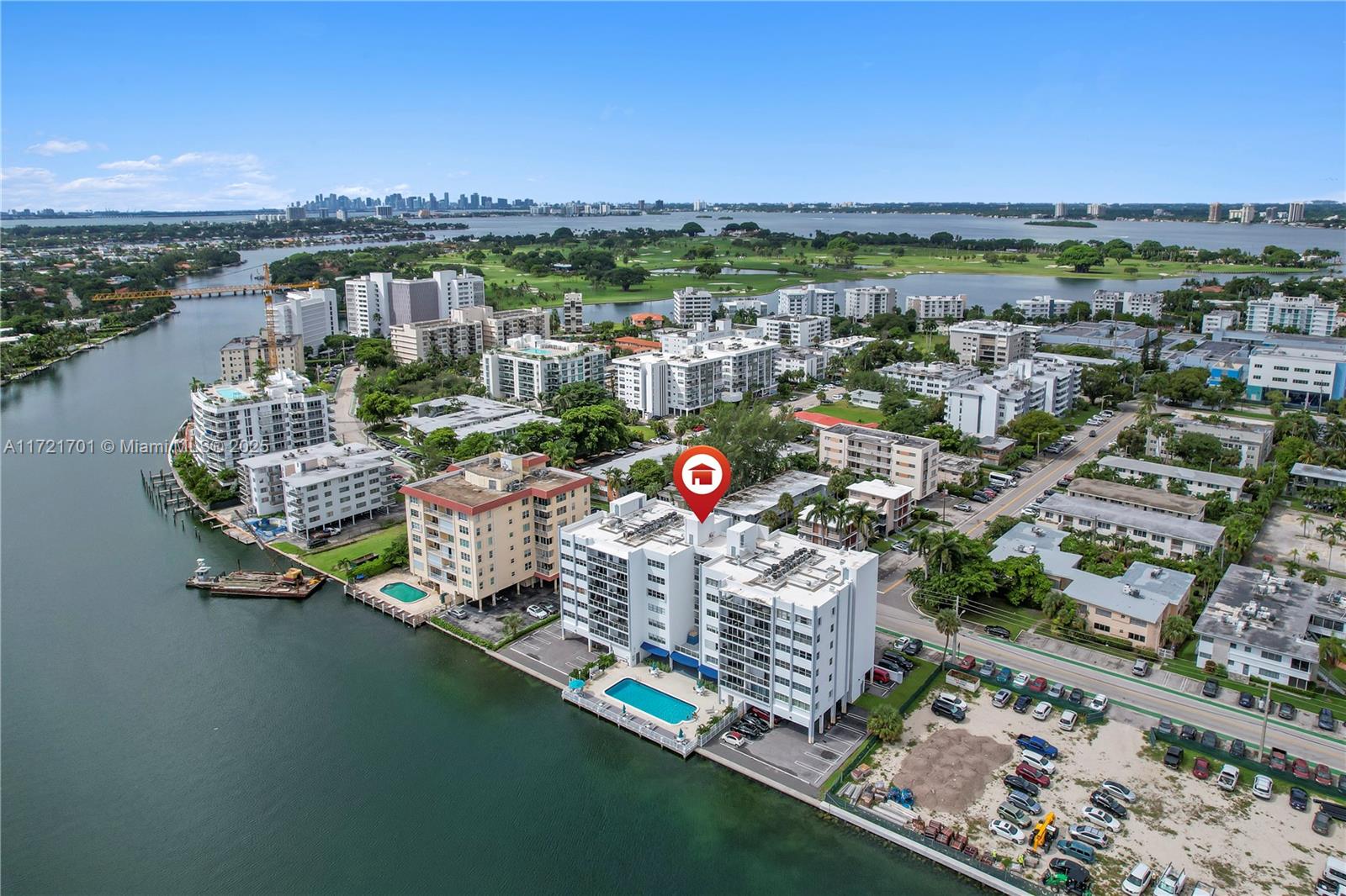 An aerial view shows a waterfront apartment building with a pool and parking lot — 9381 E Bay Harbor Dr # 401N, Bay Harbor Islands FL 33154, BAY HARBOR ISLANDS, FL
