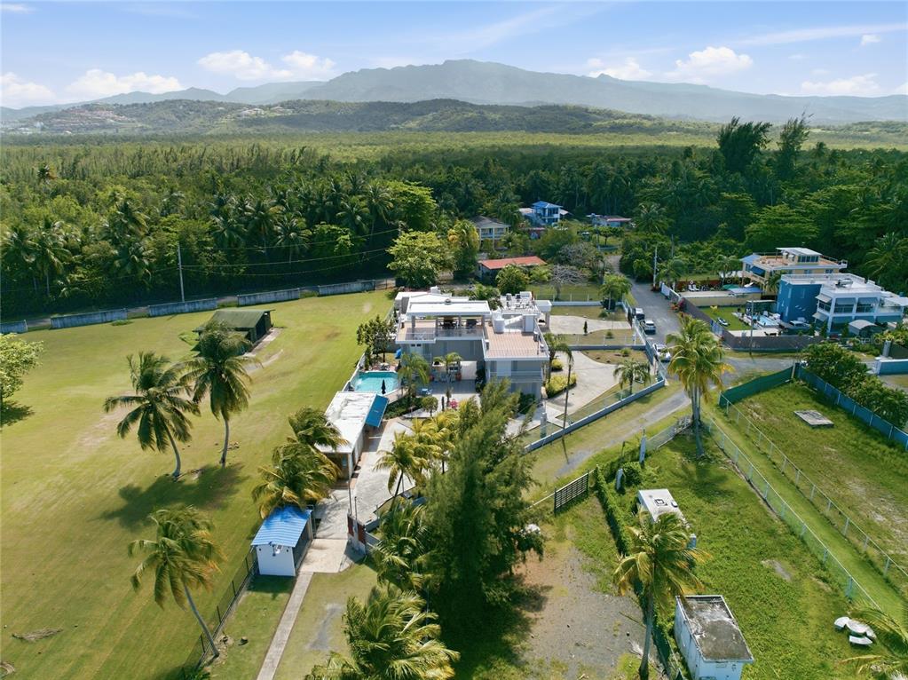 An aerial view shows a multi-story house with a swimming pool and surrounding palm trees — Pr 968k 2.1 int Punta Are LAS PICUAS, RIO GRANDE, PR