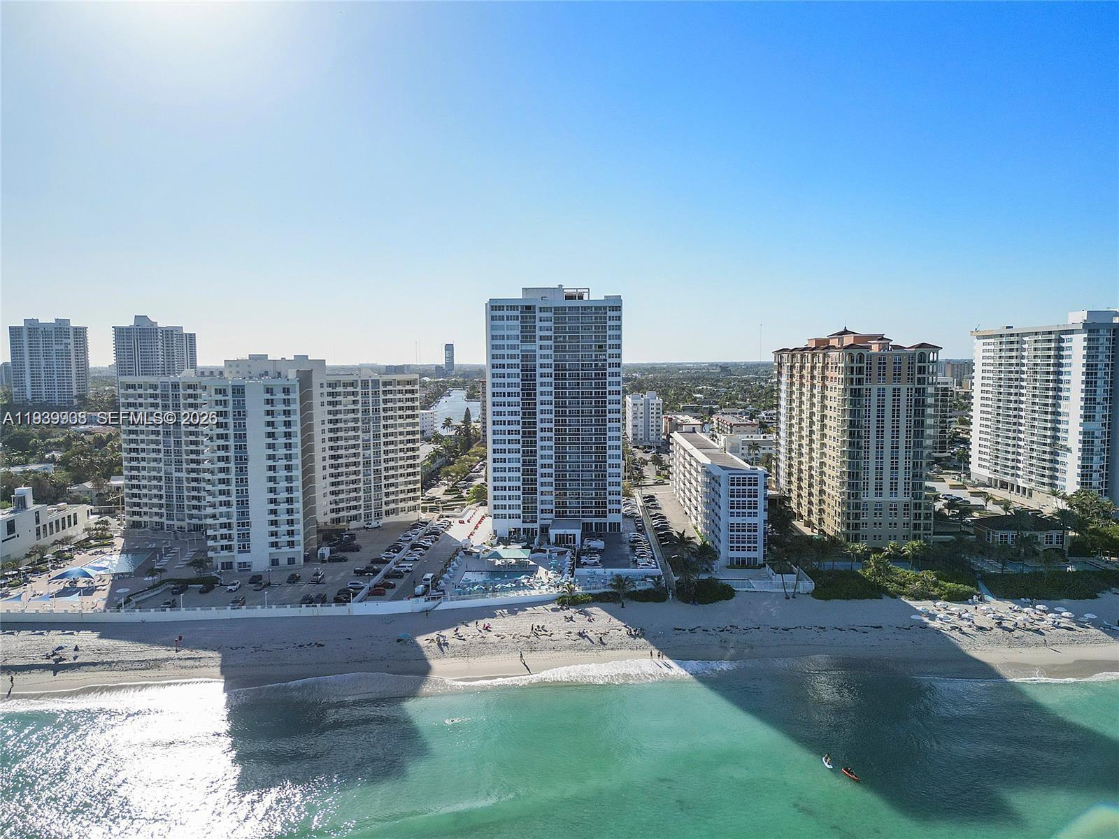 An aerial view of high-rise apartment buildings situated along a sandy beach and ocean — 3140 S Ocean Dr # 212, Hallandale Beach FL 33009, HALLANDALE BEACH, FL