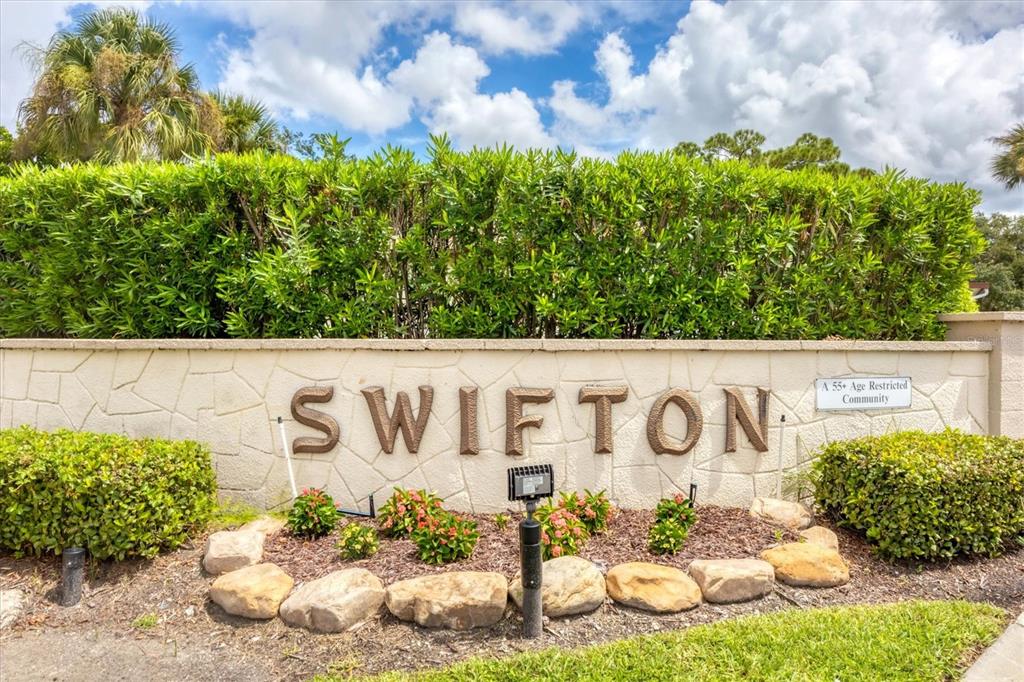A stone wall features the name SWIFTON and a 55+ age restricted community sign — 2809 SWIFTON DRIVE UNIT 4, SARASOTA, FL