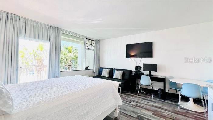 A bedroom features a bed, a black sofa, a desk with a computer, and dining chairs — 611 DESTINY DRIVE UNIT 410, RUSKIN, FL