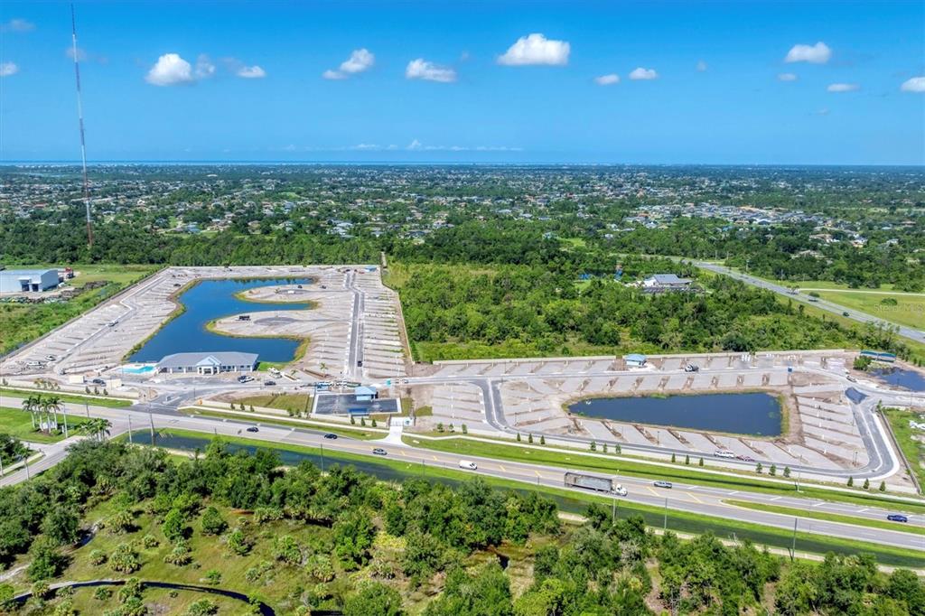 An aerial view shows a large, partially developed parking lot with two retention ponds — 9001 GASPARILLA ROAD UNIT 22, PLACIDA, FL