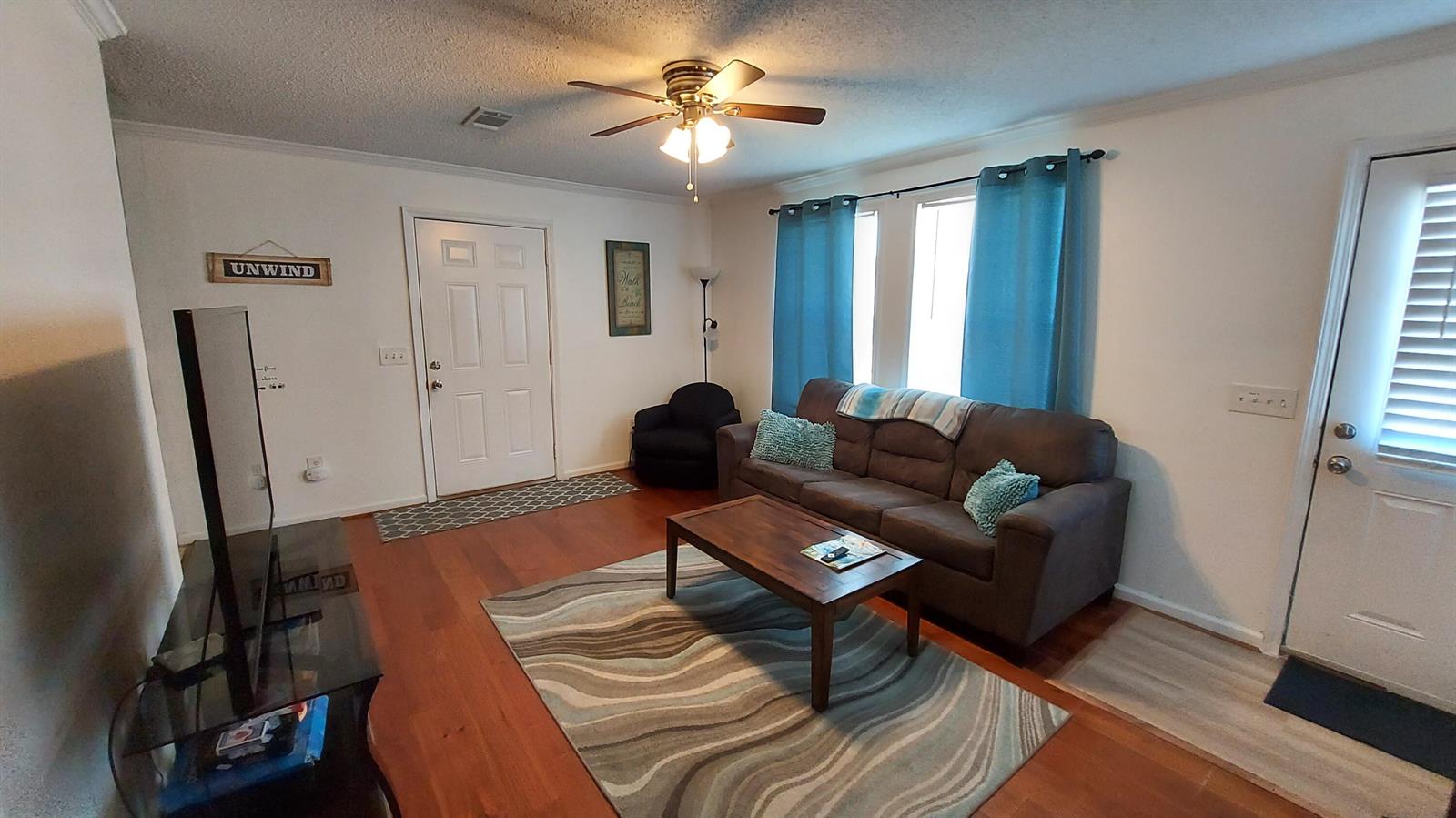 A living room features a brown sofa, a wooden coffee table, and a ceiling fan — 1401 W 9th Street, Riviera Beach FL 33404, RIVIERA BEACH, FL