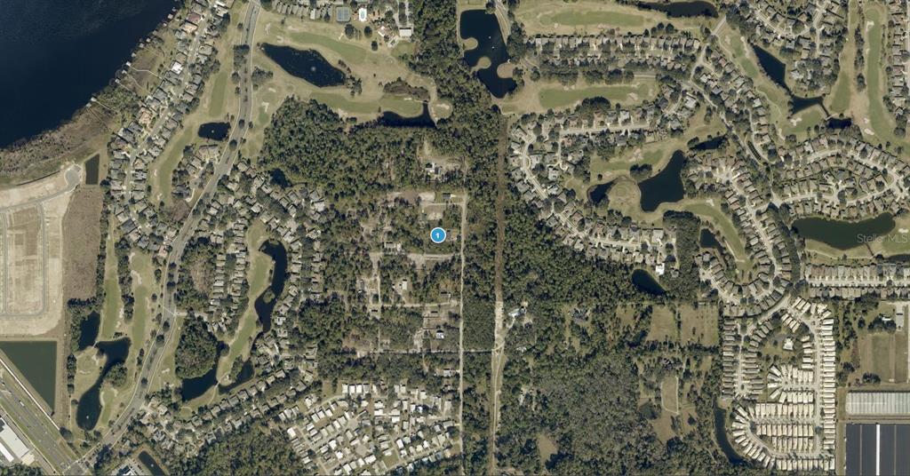 This is an aerial map view showing a residential area surrounded by golf courses and woods — SUNRISE BOULEVARD, MOUNT DORA, FL