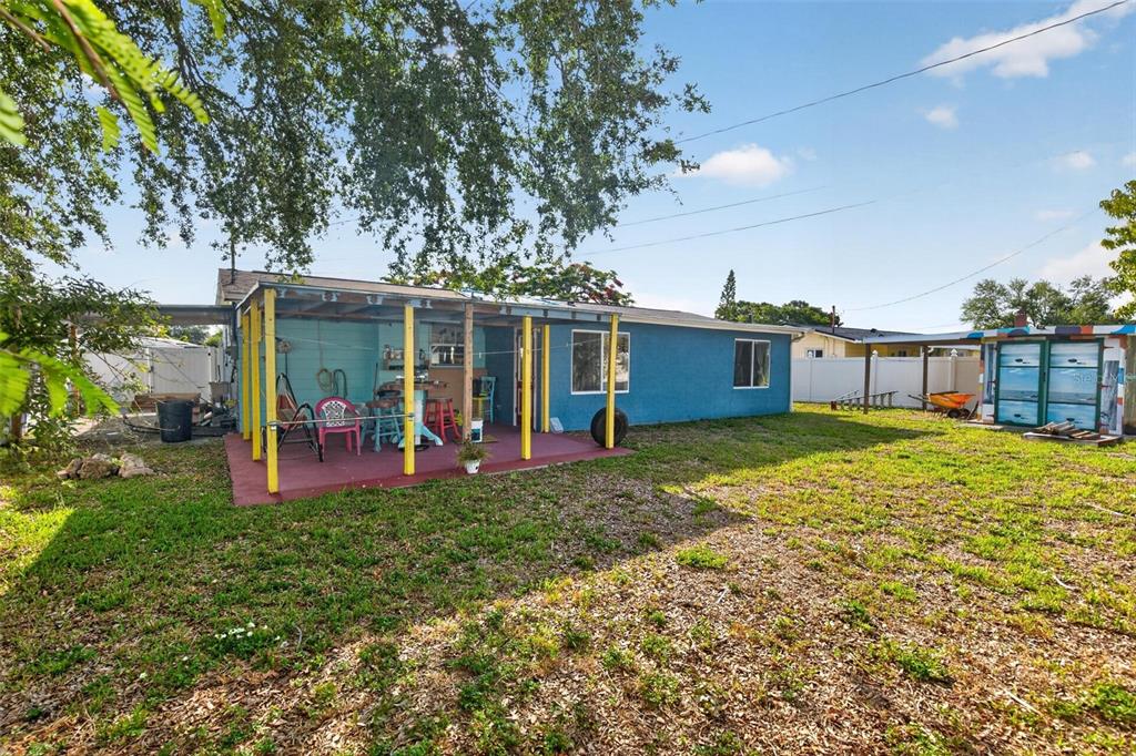 A blue house with a covered patio and a separate shed in the backyard — 3232 59TH WAY N, ST PETERSBURG, FL
