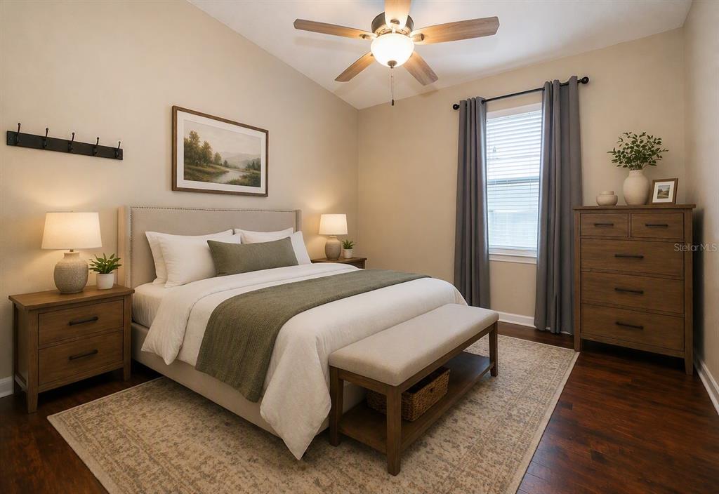 A bedroom features a bed with a green runner, a wooden dresser, and a ceiling fan — 15403 MURCOTT HARVEST LOOP, WINTER GARDEN, FL