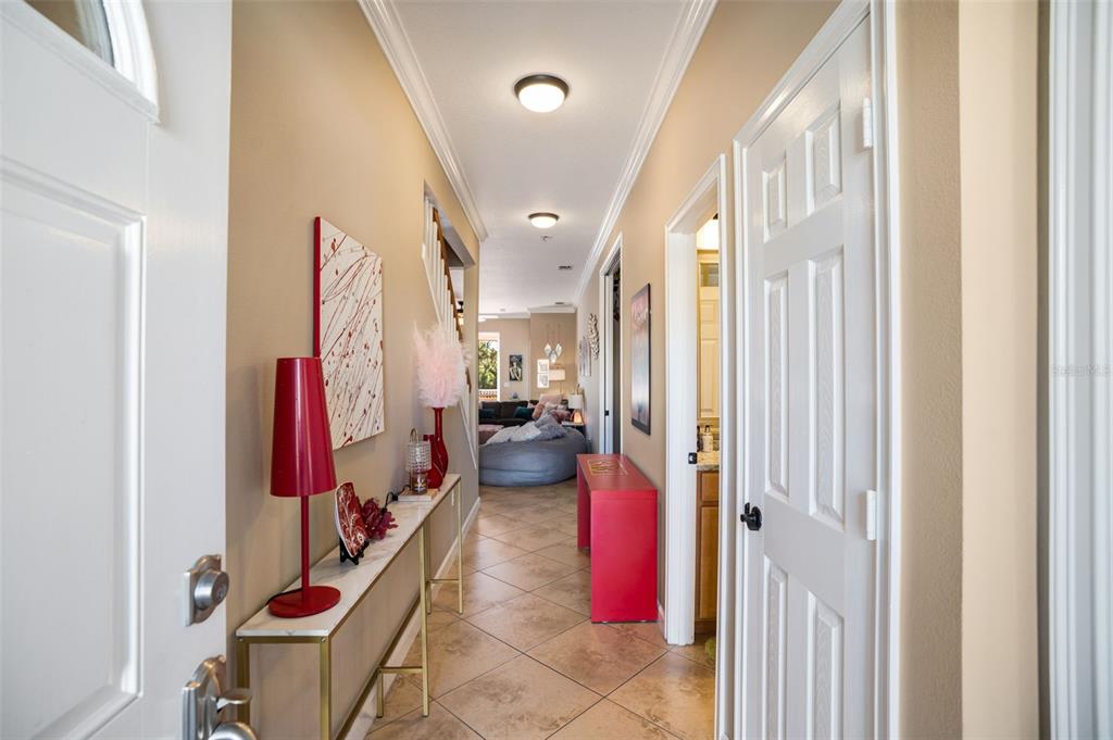 A hallway with tile floors leads from an entryway toward a living area — 2890 ASHTON ROAD UNIT 5, SARASOTA, FL