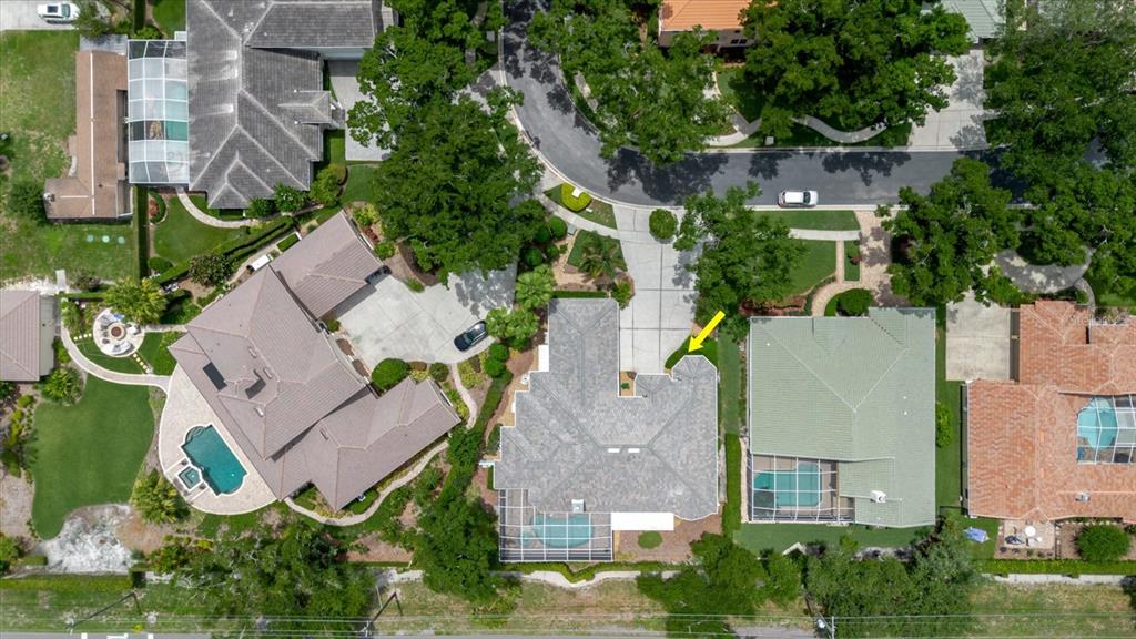 An aerial view shows a residential neighborhood with several houses, swimming pools, and paved driveways — 13510 WESTSHIRE DRIVE, TAMPA, FL