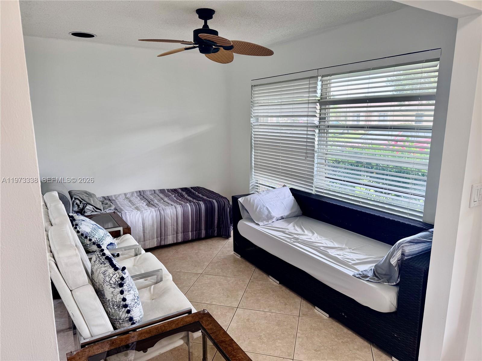 A room features a daybed, a twin bed, a white sofa, and a ceiling fan — 8838 Bella Vista Dr, Boca Raton FL 33433, BOCA RATON, FL