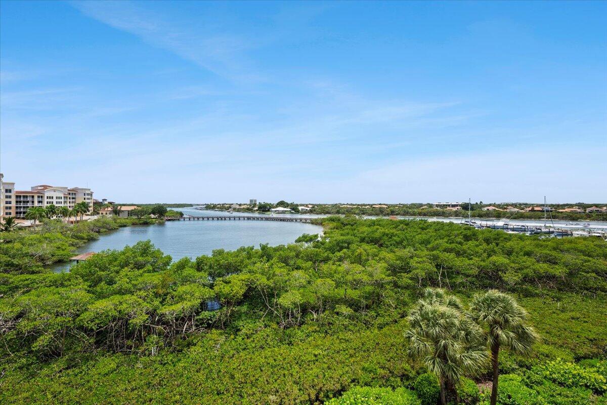 An elevated view of a mangrove forest, a calm waterway, and distant residential buildings — 500 S Us Hwy 1 # 402, Jupiter FL 33477, JUPITER, FL