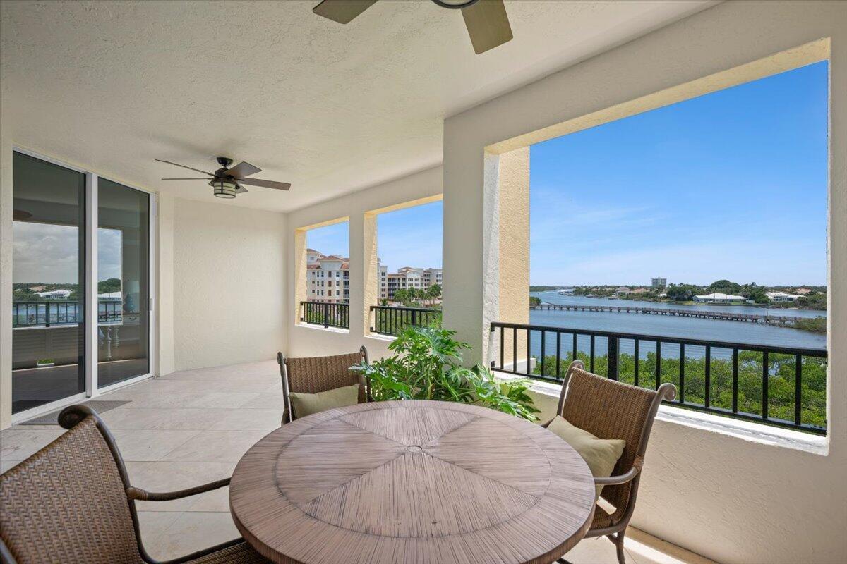 A covered balcony features a round table, chairs, and a view of the water — 500 S Us Hwy 1 # 402, Jupiter FL 33477, JUPITER, FL