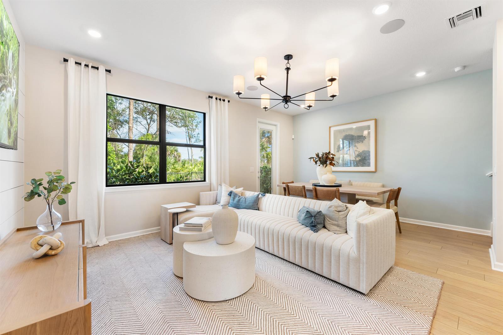 A living and dining area features a cream sectional, round coffee tables, and a chandelier — 4315 Efendi Drive, Lantana FL 33462, LANTANA, FL