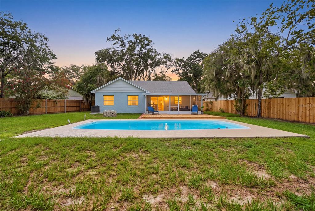 A light blue single-story house with a white garage door and a large front tree — 4637 CABBAGE PALM DRIVE, VALRICO, FL
