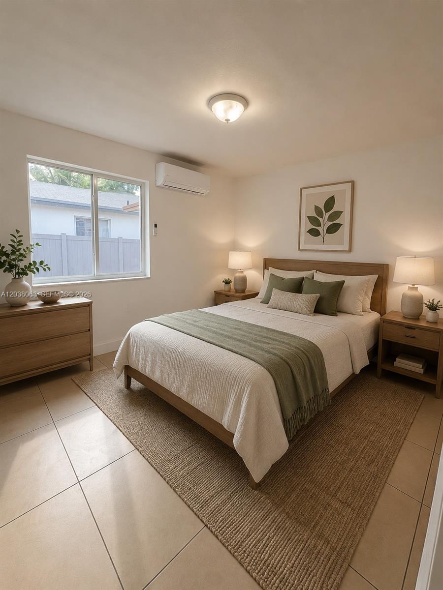 A bedroom features a bed with green accents, a wooden dresser, and tile flooring — 1857 NW 46th St # 1857, Miami FL 33142, MIAMI, FL