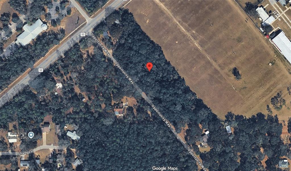 This is a satellite map view showing a wooded lot along Opportunity Way — 36520-36522-36526 COUNTY ROAD 52, DADE CITY, FL