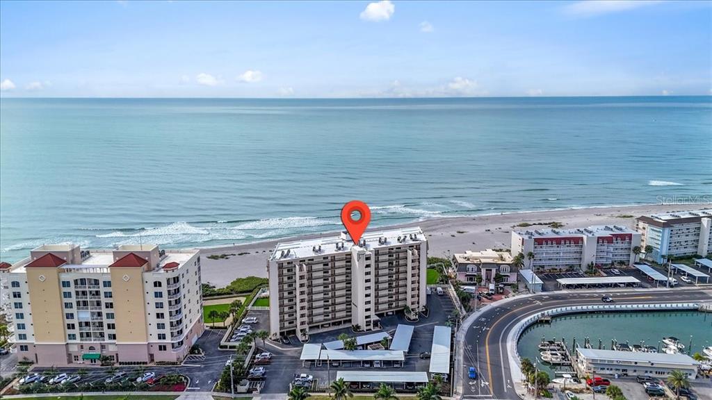 An aerial view shows a multi-story beachfront condominium building with a red location pin — 840 THE ESPLANADE N UNIT 206, VENICE, FL
