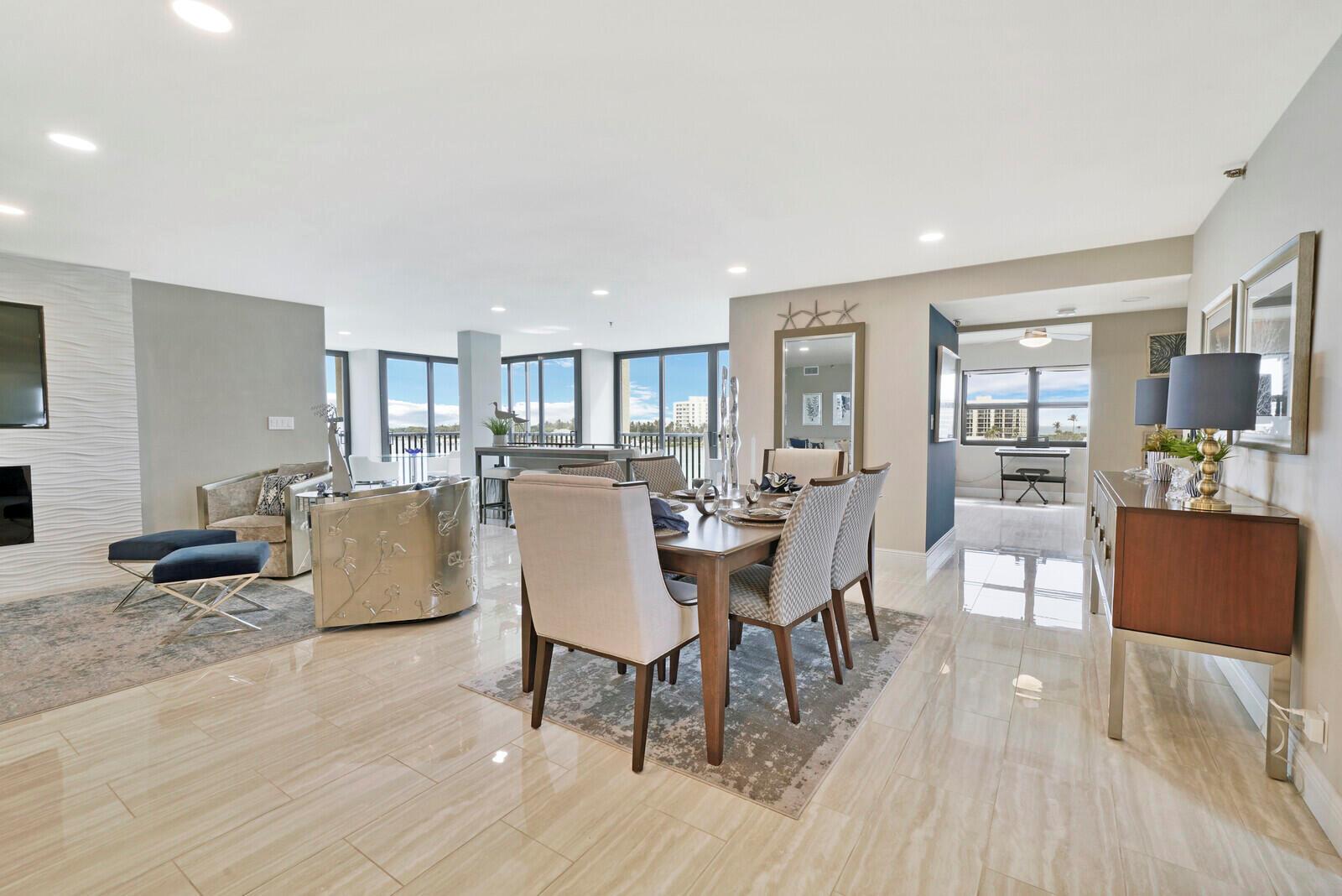 A dining area and living room feature tile floors, modern furniture, and large floor-to-ceiling windows — 19800 Sandpointe Bay Drive # 512, Tequesta FL 33469, TEQUESTA, FL