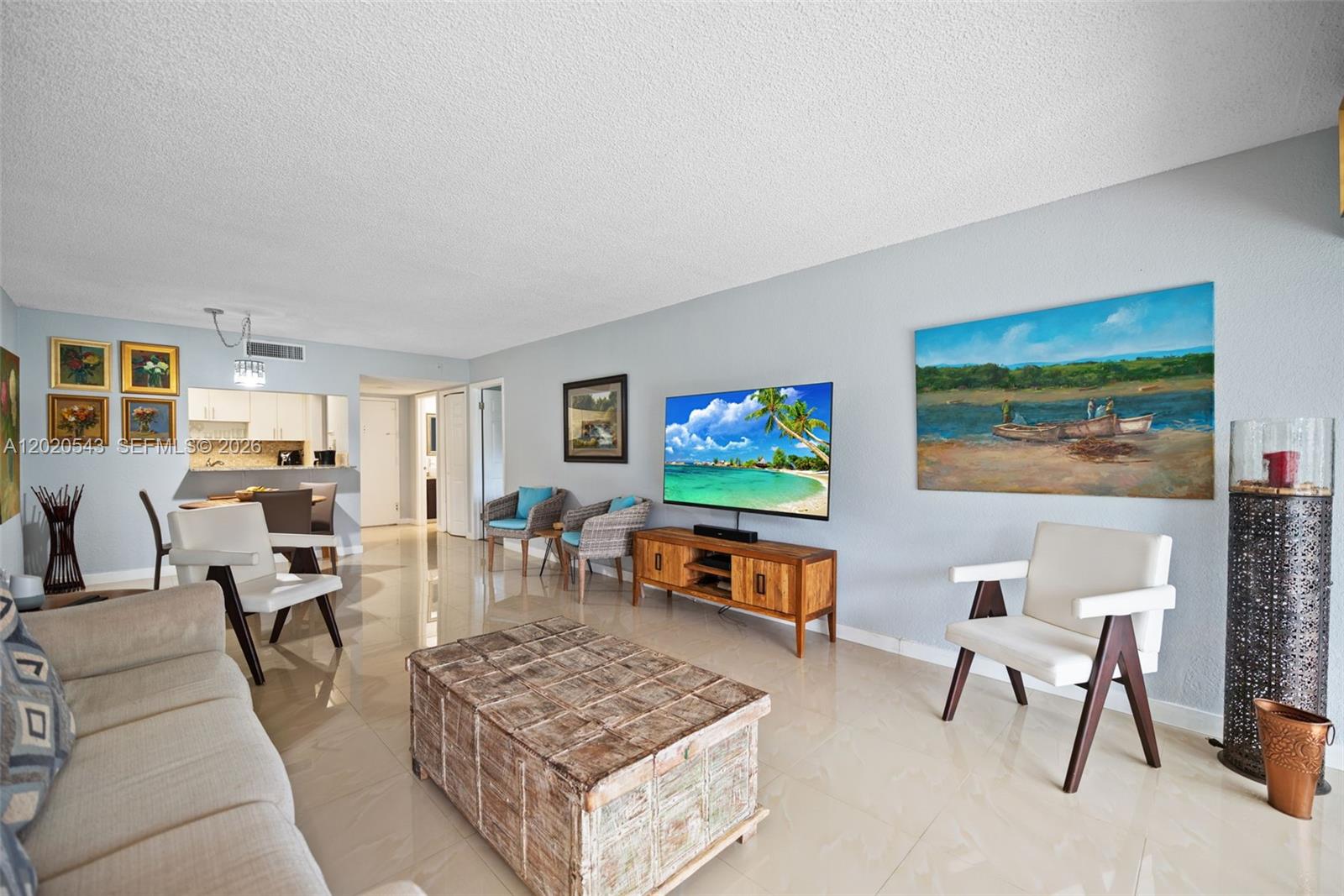 A living room features light tile floors, a wooden coffee table, and a wall-mounted television — 200 Lakeview Dr # 113, Weston FL 33326, WESTON, FL