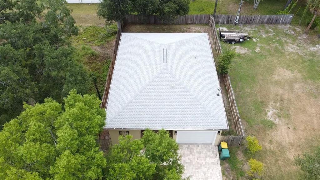 An aerial view shows a house with a light-colored hip roof and a paved driveway — 3225 LAUREL AVENUE, CLEARWATER, FL