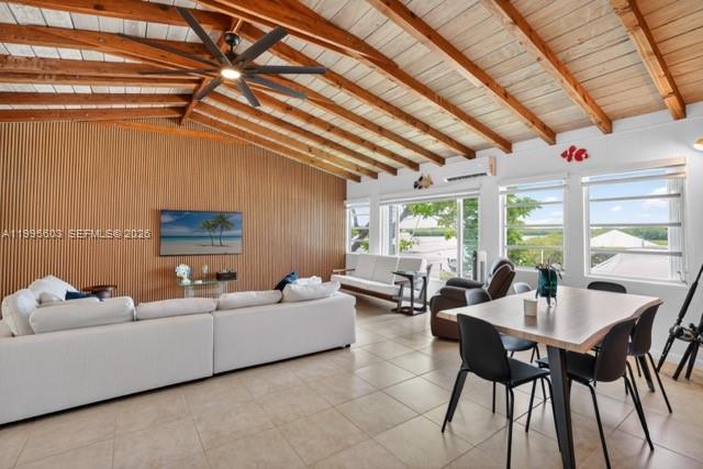 A living and dining area features a vaulted wood-beam ceiling, tile floors, and slatted walls — 1126 Grand St, Key Largo FL 33037, KEY LARGO, FL