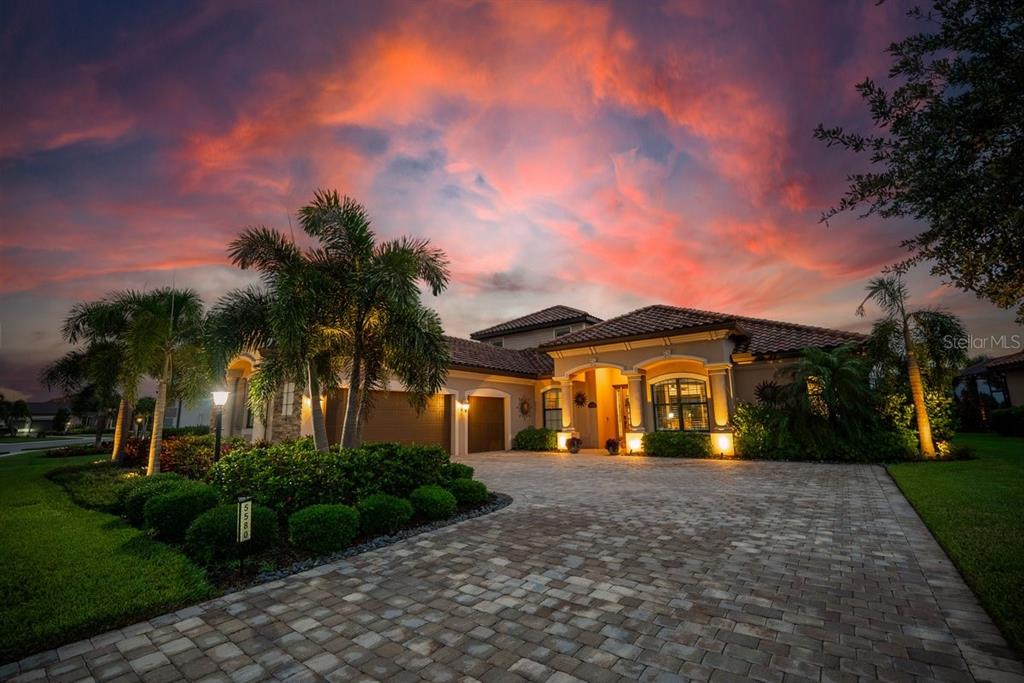 An aerial view of a suburban house with a tile roof overlooking a golf course — 5580 MULLIGAN WAY, LAKEWOOD RANCH, FL