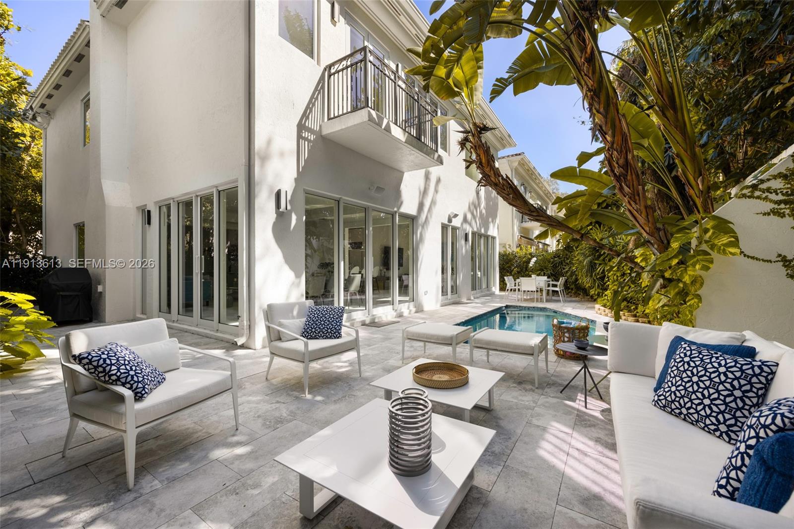 A white house exterior features a patio with outdoor furniture and a small swimming pool — 2760 Brickell Ct # 2760, Miami FL 33129, MIAMI, FL