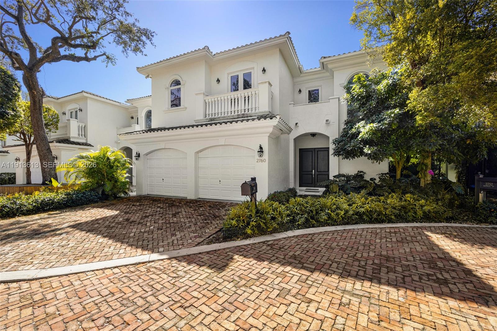 A two-story white stucco house features a brick driveway and a two-car garage — 2760 Brickell Ct # 2760, Miami FL 33129, MIAMI, FL