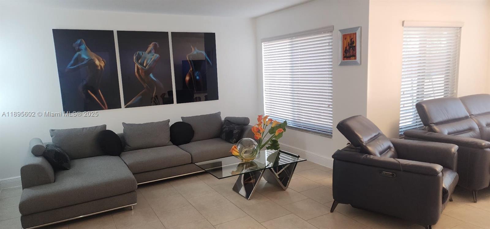 A living room features a grey sectional sofa, a glass coffee table, and three large artworks — 13208 SW 10th Ln, Miami FL 33184, MIAMI, FL