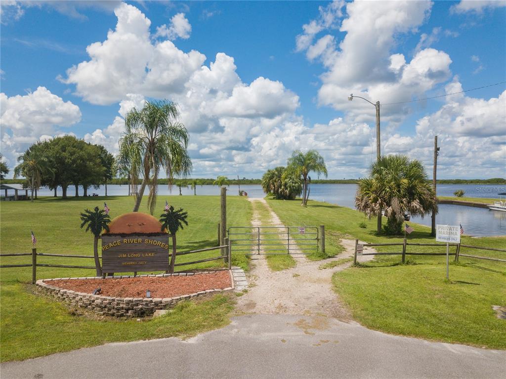 A gated entrance leads to a private marina on Jim Long Lake — 38 GRAPE AVENUE, PUNTA GORDA, FL