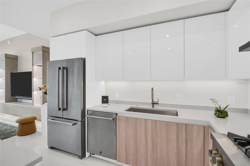 A modern kitchen features stainless steel appliances, white upper cabinets, and light wood lower cabinets — 400 CENTRAL AVENUE UNIT 2705, ST PETERSBURG, FL