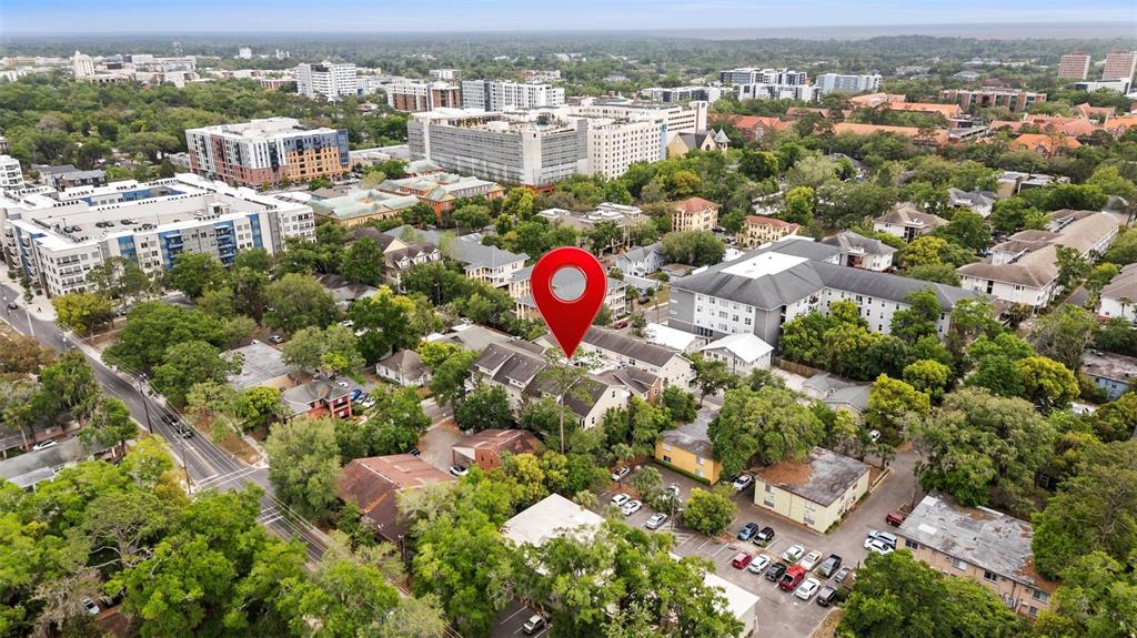 An aerial view shows a residential neighborhood with a red map pin marking a building — 1500 NW 4TH AVENUE UNIT 208, GAINESVILLE, FL